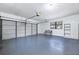 Large garage with overhead door and storage shelving at 3520 Wilderness W Blvd, Parrish, FL 34219