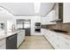 Modern white kitchen with stainless steel appliances and marble countertops at 3520 Wilderness W Blvd, Parrish, FL 34219