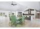 Modern kitchen with white cabinets, marble island, and green chairs at 3520 Wilderness W Blvd, Parrish, FL 34219