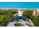 Aerial view of beachfront property with lush landscaping, parking and access to the beach at 380 Gulf Of Mexico Dr # 536, Longboat Key, FL 34228