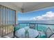 Relax on this inviting balcony with a glass table, comfortable seating, and stunning ocean views at 380 Gulf Of Mexico Dr # 536, Longboat Key, FL 34228