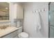 Clean, well-lit bathroom with a sink, toilet, cabinet, towel rack, and glass-enclosed shower at 380 Gulf Of Mexico Dr # 536, Longboat Key, FL 34228