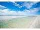 Expansive beach with shallow water and clear blue sky, offering a serene coastal view at 380 Gulf Of Mexico Dr # 536, Longboat Key, FL 34228