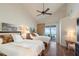 Bright bedroom featuring two beds, wood floors, and private balcony with ocean view at 380 Gulf Of Mexico Dr # 536, Longboat Key, FL 34228