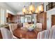 Dining room with view of the kitchen, wood floors, and decorative chandelier at 380 Gulf Of Mexico Dr # 536, Longboat Key, FL 34228