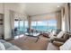 Bright and airy living room with ocean views, comfortable seating, and sliding doors to balcony at 380 Gulf Of Mexico Dr # 536, Longboat Key, FL 34228