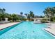 Large community pool with clear blue water surrounded by tropical landscaping and resort buildings at 380 Gulf Of Mexico Dr # 536, Longboat Key, FL 34228