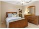 Bedroom with queen bed and wooden dresser at 4104 Reflections Pkwy, Sarasota, FL 34233