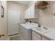 Laundry room with washer, dryer, cabinets and sink at 4104 Reflections Pkwy, Sarasota, FL 34233