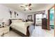 Bedroom featuring ceiling fan, tile floors, and en suite bathroom at 4410 70Th E Dr, Sarasota, FL 34243