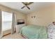 Bedroom with ceiling fan, large window, and TV at 4410 70Th E Dr, Sarasota, FL 34243