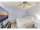 Cozy bedroom featuring neutral paint, tile floors, ceiling fan and flat screen tv at 4410 70Th E Dr, Sarasota, FL 34243