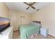 Cozy bedroom with tiled floors, a ceiling fan, and neutral wall colors at 4410 70Th E Dr, Sarasota, FL 34243