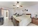 Bedroom featuring ceiling fan, tile floors, and ensuite bathroom at 4410 70Th E Dr, Sarasota, FL 34243