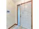 Light-colored interior entry door with sidelight at 4410 70Th E Dr, Sarasota, FL 34243