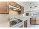 White stove and oven with wood cabinets in kitchen at 4410 70Th E Dr, Sarasota, FL 34243