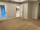 Large carpeted bedroom with views of kitchen and doorways to other rooms at 4432 Collingswood Blvd, Port Charlotte, FL 33948