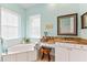 Bathroom with granite countertop, soaking tub and window at 4941 Bridgehampton Blvd, Sarasota, FL 34238