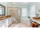 Spa-like bathroom with granite, soaking tub, and walk-in shower at 4941 Bridgehampton Blvd, Sarasota, FL 34238