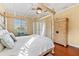 Spacious bedroom with four-poster bed, hardwood floors and large closet at 4941 Bridgehampton Blvd, Sarasota, FL 34238