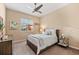 Cozy bedroom with a comfortable bed, nightstand and ceiling fan at 4941 Bridgehampton Blvd, Sarasota, FL 34238