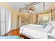 Spacious bedroom with a four-poster bed and hardwood floors at 4941 Bridgehampton Blvd, Sarasota, FL 34238