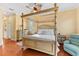 Bedroom with four-poster bed, ceiling fan, and access to backyard at 4941 Bridgehampton Blvd, Sarasota, FL 34238