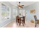 Bright breakfast nook with table, four chairs, and plantation shutters at 4941 Bridgehampton Blvd, Sarasota, FL 34238