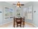 Bright breakfast nook boasts wood table and three windows with shutters at 4941 Bridgehampton Blvd, Sarasota, FL 34238