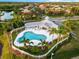 Community pool with clubhouse and surrounding landscaping at 4941 Bridgehampton Blvd, Sarasota, FL 34238