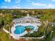 Community pool with clubhouse and lush landscaping at 4941 Bridgehampton Blvd, Sarasota, FL 34238