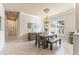 Bright dining room featuring a wooden table and bench, and a chandelier at 4941 Bridgehampton Blvd, Sarasota, FL 34238