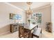 Bright dining room featuring a wooden table and bench, and a chandelier at 4941 Bridgehampton Blvd, Sarasota, FL 34238