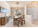 Bright dining room featuring a wooden table and bench, and a chandelier at 4941 Bridgehampton Blvd, Sarasota, FL 34238