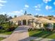 Single-Gathering home with tile roof, landscaping, and long driveway at 4941 Bridgehampton Blvd, Sarasota, FL 34238