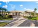 Single-story home with a tile roof, two-car garage, and landscaped yard at 4941 Bridgehampton Blvd, Sarasota, FL 34238