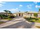 Single-story home with tile roof, two-car garage, and landscaped yard at 4941 Bridgehampton Blvd, Sarasota, FL 34238