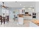 Kitchen with white cabinets, granite countertops, and breakfast bar at 4941 Bridgehampton Blvd, Sarasota, FL 34238