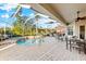 Relaxing screened pool area with patio furniture and hot tub at 4941 Bridgehampton Blvd, Sarasota, FL 34238