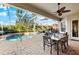 Relaxing screened-in pool and patio with outdoor dining at 4941 Bridgehampton Blvd, Sarasota, FL 34238