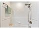 Clean shower with white tile and a handheld showerhead at 4941 Bridgehampton Blvd, Sarasota, FL 34238