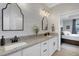 Modern bathroom with double vanity, granite countertop and a view of the bedroom at 5035 Seafoam Trl, Bradenton, FL 34211