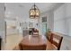 Dining room with a wood table, chandelier, and view of kitchen at 5035 Seafoam Trl, Bradenton, FL 34211