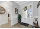 Bright and airy entryway with white door and wainscoting at 5035 Seafoam Trl, Bradenton, FL 34211