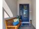 Inviting front entry with blue door and wooden bench at 5035 Seafoam Trl, Bradenton, FL 34211