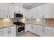 Kitchen with stainless steel appliances and white cabinets at 5035 Seafoam Trl, Bradenton, FL 34211