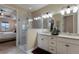 Elegant bathroom with double vanity, glass shower, and view of bedroom at 5233 Blossom Cv, Lakewood Ranch, FL 34211