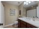 Clean bathroom with a white vanity and decorative shower curtain at 5233 Blossom Cv, Lakewood Ranch, FL 34211