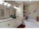 Double vanity bathroom with soaking tub and granite countertops at 5233 Blossom Cv, Lakewood Ranch, FL 34211