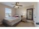 Cozy bedroom with a full-size bed and a large mirror at 5233 Blossom Cv, Lakewood Ranch, FL 34211